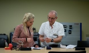 Professor John Veitch works with a student in a boot camp program