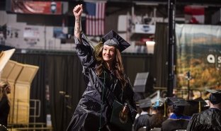 A graduate cheers after receiving their diploma at the 2026 commencement at Harding Mazzotti Arena.