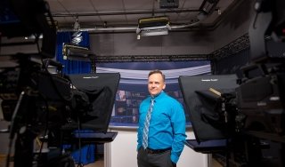 Distinguished Professor of Broadcast Media Kevin Ankeny is seen in the TV studio on campus