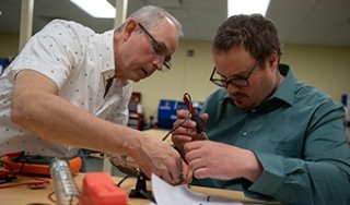 SUNY Adirondack professor John Veitch helps a student