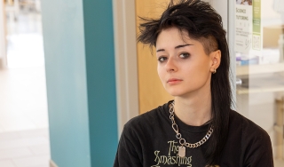Amber Rzeszuto wears a Smashing Pumpkins T-shirt, has black, spiky hair and is looking directly at the camera