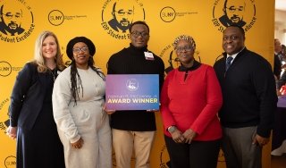 SUNY Adirondack student Xavier Baker celebrates receiving the Norman R. McConney Jr. Award for Student Excellence on March 10, with SUNY Adirondack President Anastasia L. Urtz, J.D., left, SUNY Adirondack EOP Director Sam Johnson, right, and Baker's mother and grandmother.