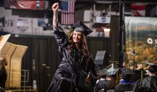 A graduate cheers after receiving their diploma at the 2026 commencement at Harding Mazzotti Arena.