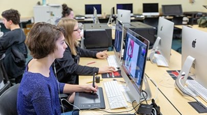 Students work on a project in an on-campus Mac lab