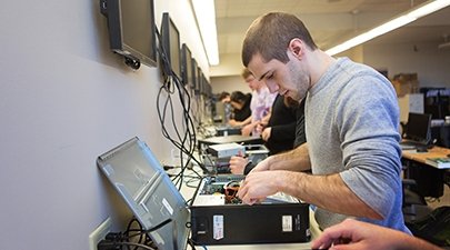 A student works on equipment in a Computer Science lab on campus