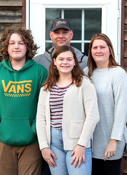 Roger Harrington is shown with his family outside their home. Harrington spent more than eight years earning a degree while working full time.