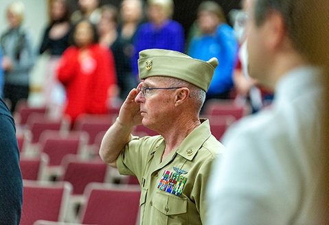 A veteran salutes during a Veterans Day ceremony at SUNY Adirondack.