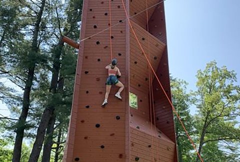 A veteran climbs a wall on a camping trip