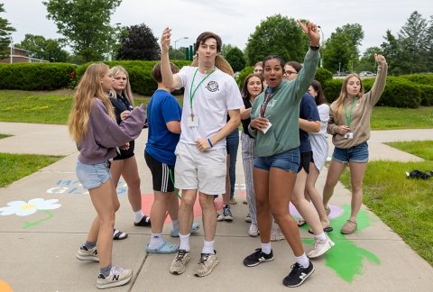 Students in Upward Bound run through an activity outside the Residence Hall